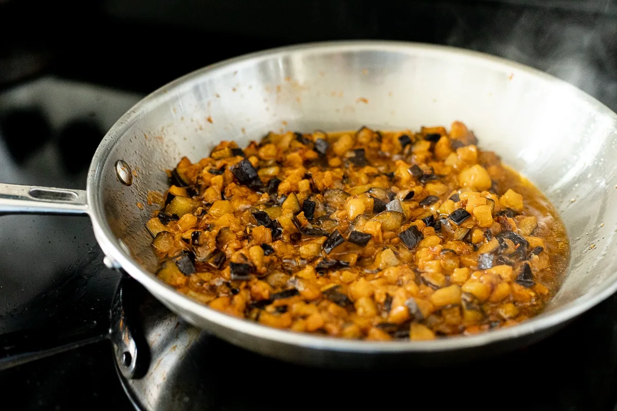 eggplant and tomato sauce frying in a pan